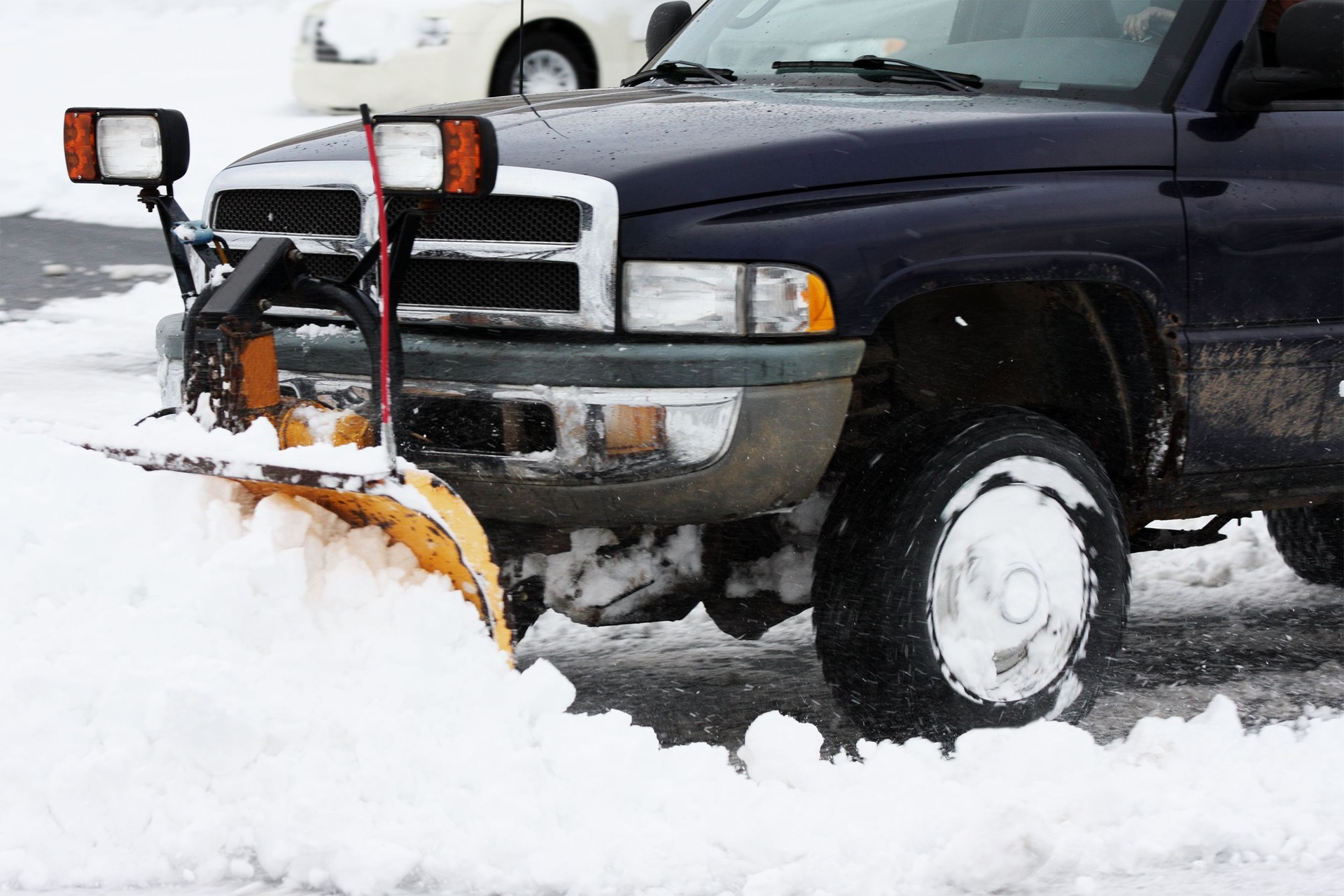 huge truck with plow removing snow