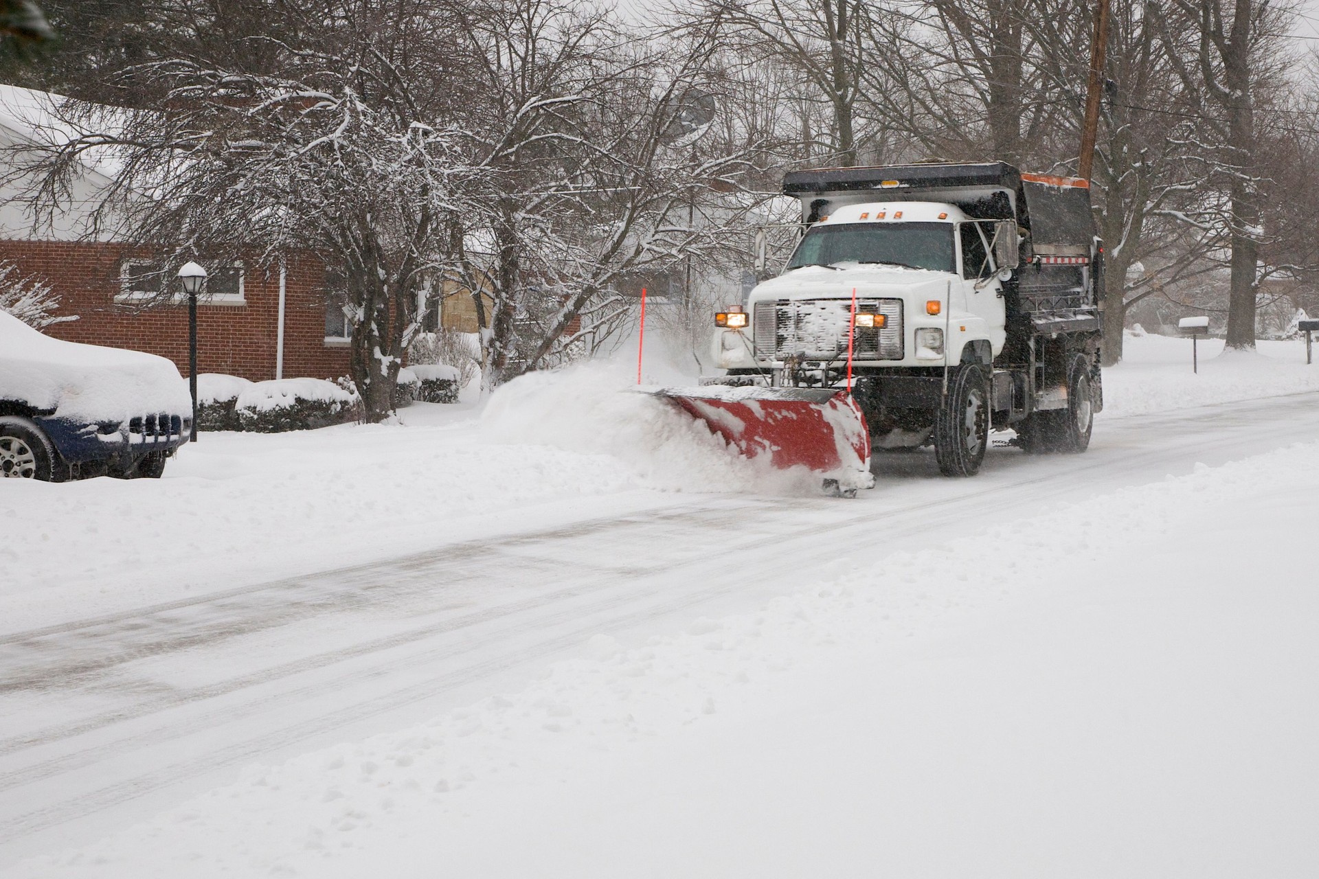 Snow plow removing snow from street.